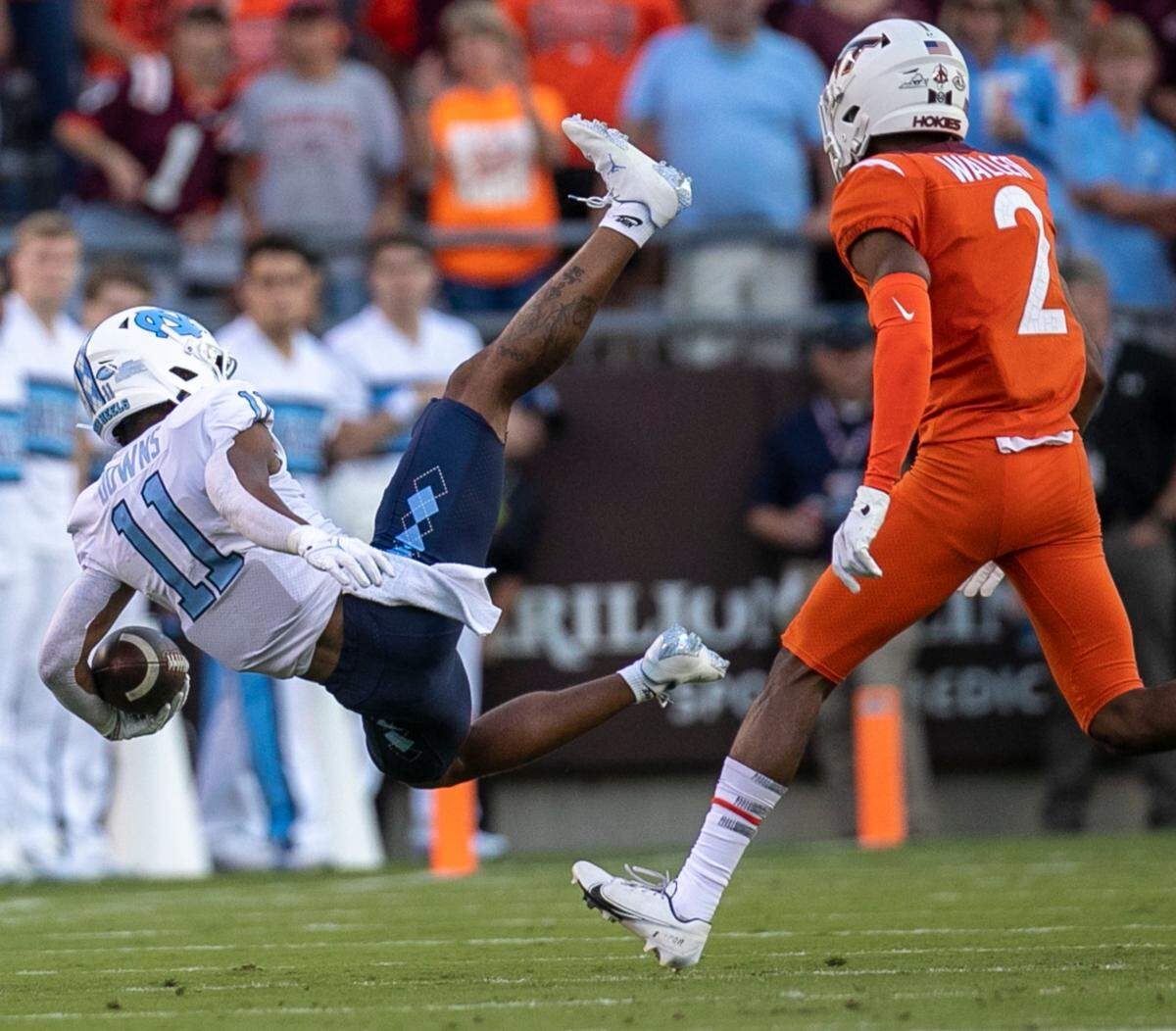 North Carolina wide receiver Josh Downs (11) falls to the ground after a pass reception from Sam Howell (7) in the second quarter on Friday, September 3, 2021 at Lane Stadium in Blacksburg, Va.