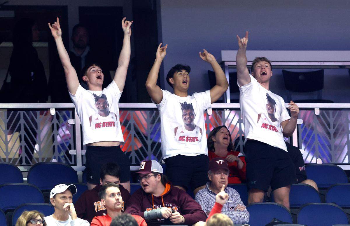 N.C. State fans cheer on the Wolfpack during the second half of N.C. State’s 97-77 victory over Virginia Tech in the second round of the ACC Men’s Basketball Tournament in Greensboro, N.C., Wednesday, March 8, 2023.