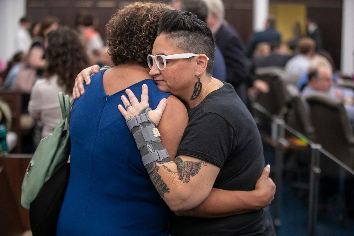 Suzy Geronimo of Henderson, N.C., left, embraces Gwenn Mangine of Cary, N.C., after they were not allowed to speak at a public hearing on the Youth Protection Act, during a House Committee on Health meeting on Tuesday, May 2, 2023 at the Legislative Office Building in Raleigh, N.C.  The legislation would ban certain gender-affirming care for minors.