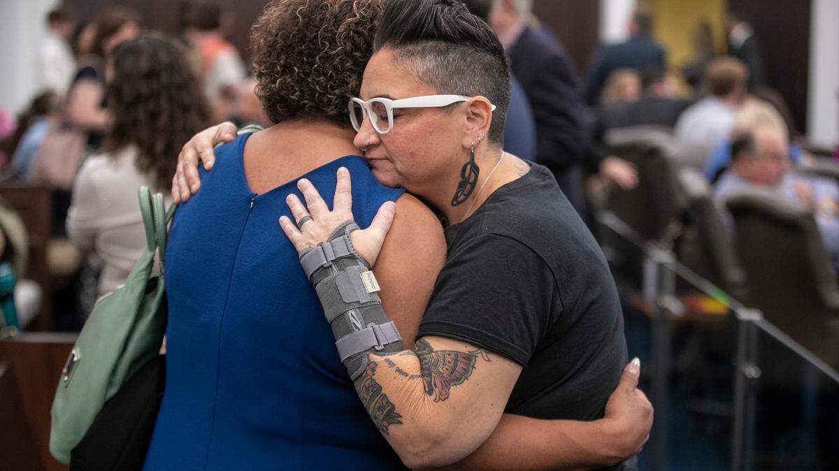Suzy Geronimo of Henderson, N.C., left, embraces Gwenn Mangine of Cary, N.C., after they were not allowed to speak at a public hearing on the Youth Protection Act, during a House Committee on Health meeting on Tuesday, May 2, 2023 at the Legislative Office Building in Raleigh, N.C. The legislation would ban gender-affirming care for minors.