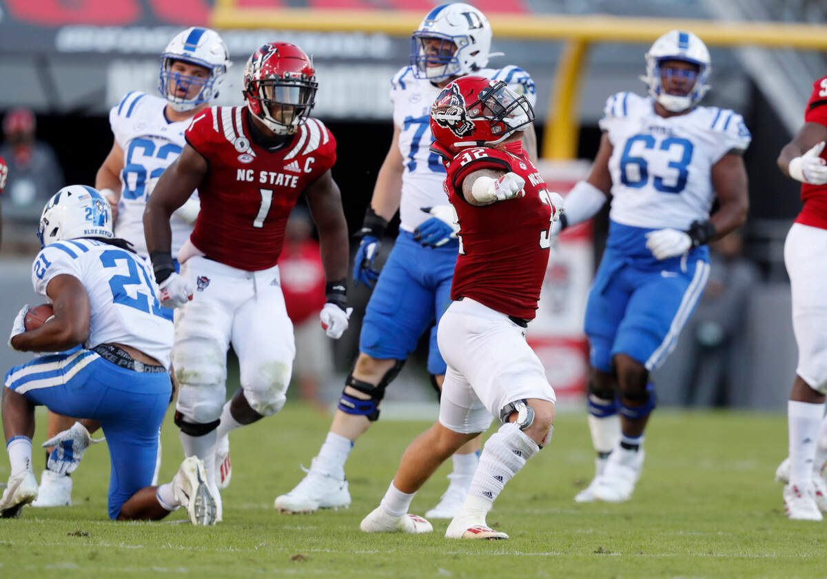 N.C. State linebacker Drake Thomas (32) celebrates after tackling Duke running back Mataeo Durant (21) for a loss during the first half of N.C. State’s game against Duke at Carter-Finley Stadium in Raleigh, N.C., Saturday, Oct. 17, 2020.