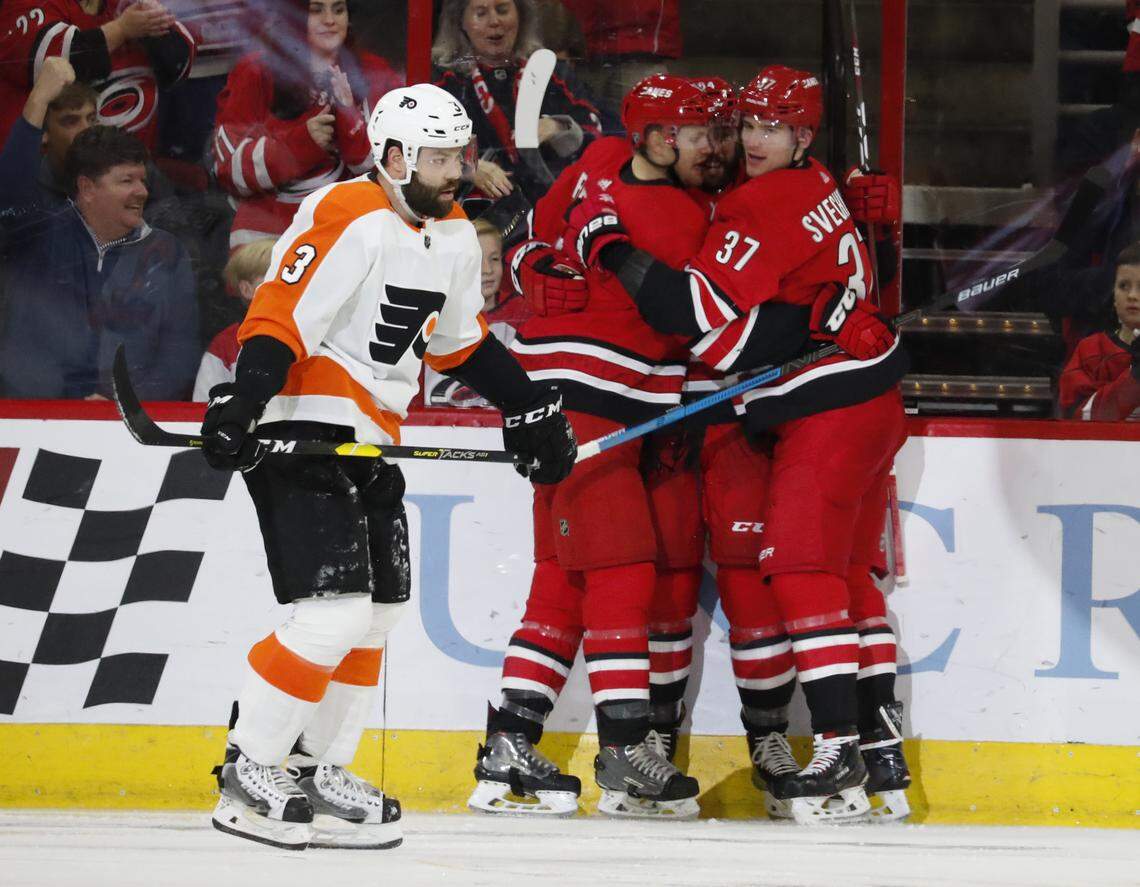 The Carolina Hurricanes celebrate a goal by Andrei Svechnikov as Philadelphia Flyers’ Radko Gudas (3) skates by during the second period of an NHL hockey game, Monday, Dec. 31, 2018, in Raleigh, N.C. (AP Photo/Karl B DeBlaker)