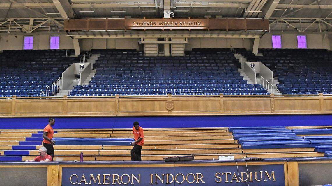 Workers place seats in Cameron Indoor Stadium, Thursday, Aug. 23, 2018. A new addition to the Blue Devils stadium is the overhead press area.  Formerly accessible only by ladders before the game, at halftime and afterward, the newly renovated area has stairs and a larger area for seating.