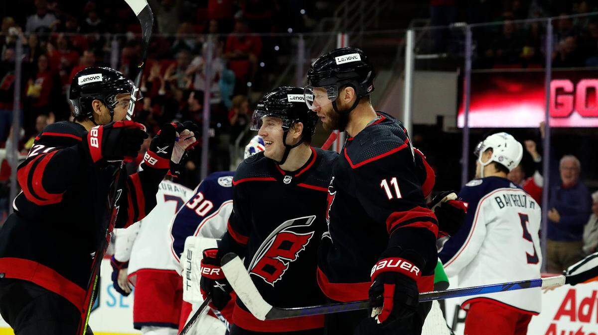 Carolina Hurricanes’ Jordan Staal (11) is congratulated on his goal by teammates Jesper Fast (71) and Nino Niederreiter (21) during the second period of an NHL hockey game against the Columbus Blue Jackets in Raleigh, N.C., Friday, Feb. 25, 2022. (AP Photo/Karl B DeBlaker)