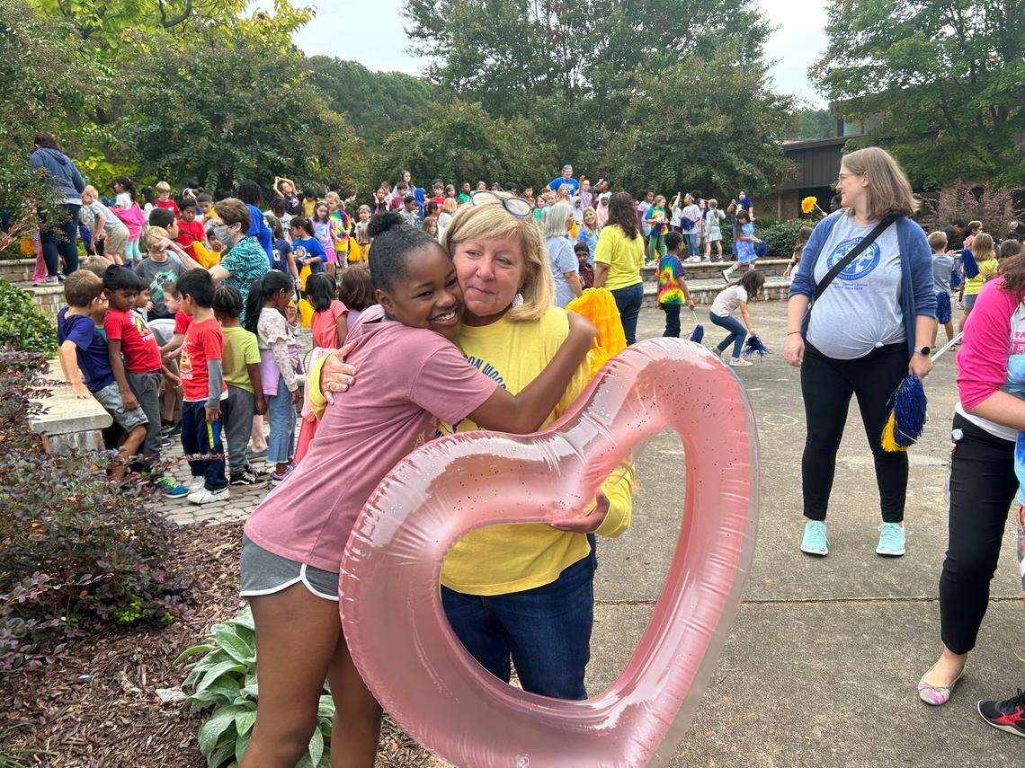 Students at Farmington Woods Elementary School in Cary, N.C., rush up to Winston Pierce on Oct. 6, 2023 to celebrate her being named Wake County’s 2023-24 Principal of the Year.