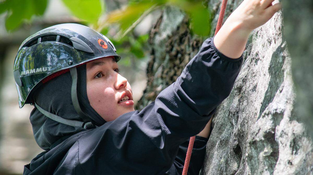 Sughra Yazdani, a 21-year-old Afghan woman living in Durham, climbs the ‘Fear of Flying’ climbing area at Pilot Mountain State Park, north of Winston-Salem on Sunday, May 15, 2022.