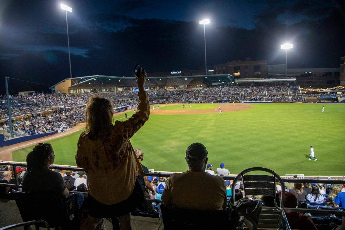 Fans cheer as the Durham Bulls play their season opener against the Jacksonville Jumbo Shrimp at the Durham Bulls Athletic Park, Tuesday, April 12, 2022.