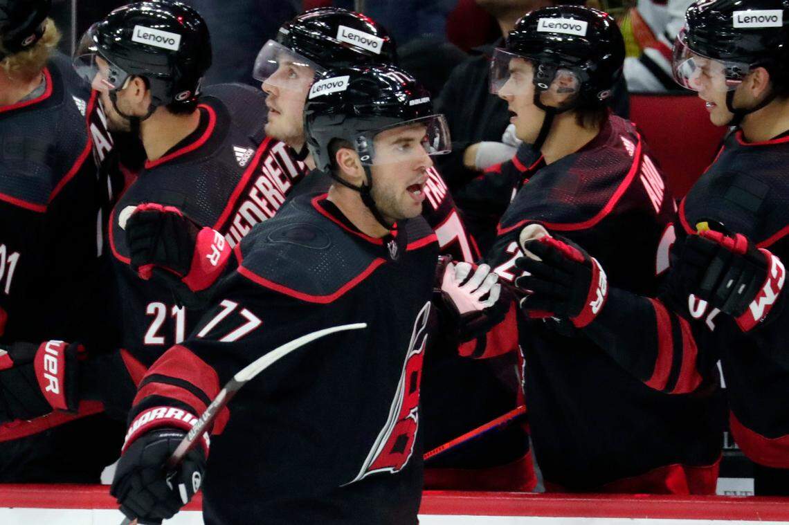 Carolina Hurricanes defenseman Tony DeAngelo (77) celebrates his goal as he comes back to the bench during the first period of an NHL hockey game against the Chicago Blackhawks Friday, Oct. 29, 2021, in Raleigh, N.C. (AP Photo/Chris Seward)