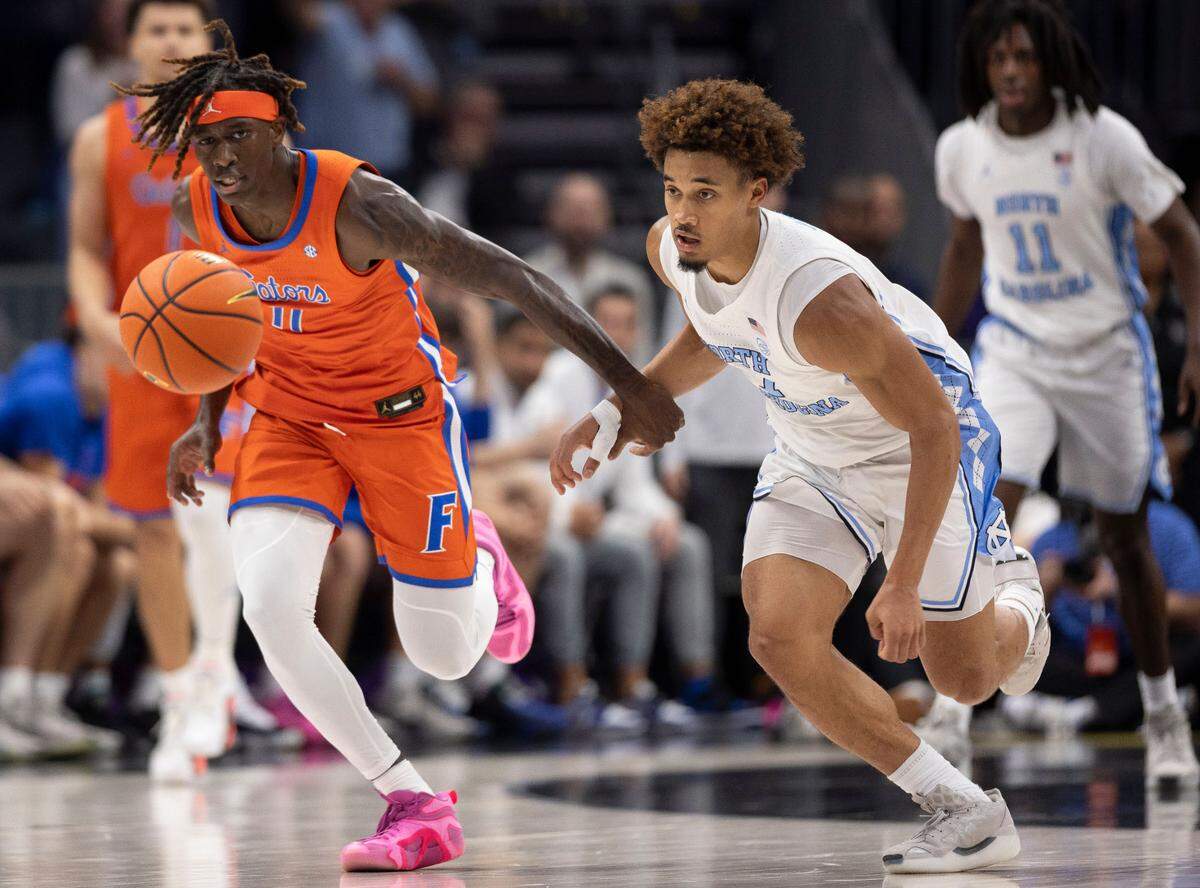North Carolina guard Seth Trimble (7) makes a steal from Florida’s Denzel Aberdeen (11) in the second half during the Jumpman Invitational on Tuesday, December 17, 2024 at the Spectrum Center in Charlotte, N.C. North Carolina fell 90-84 to Florida.