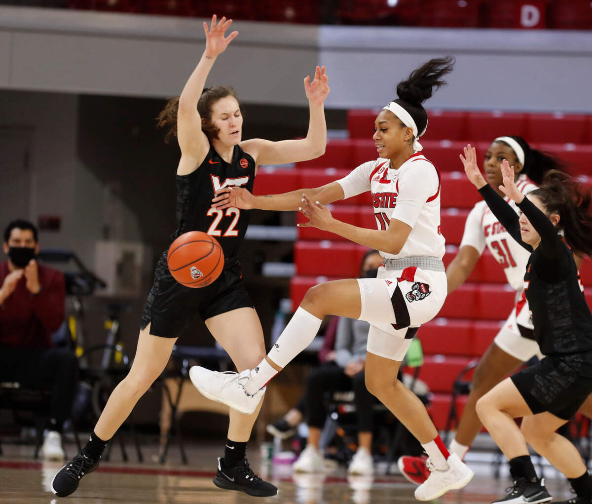 Virginia Tech’s Cayla King (22) knocks the ball from N.C. State’s Jakia Brown-Turner (11) during the first half of N.C. State’s game against Virginia Tech at Reynolds Coliseum in Raleigh, N.C., Sunday, January 24, 2021.