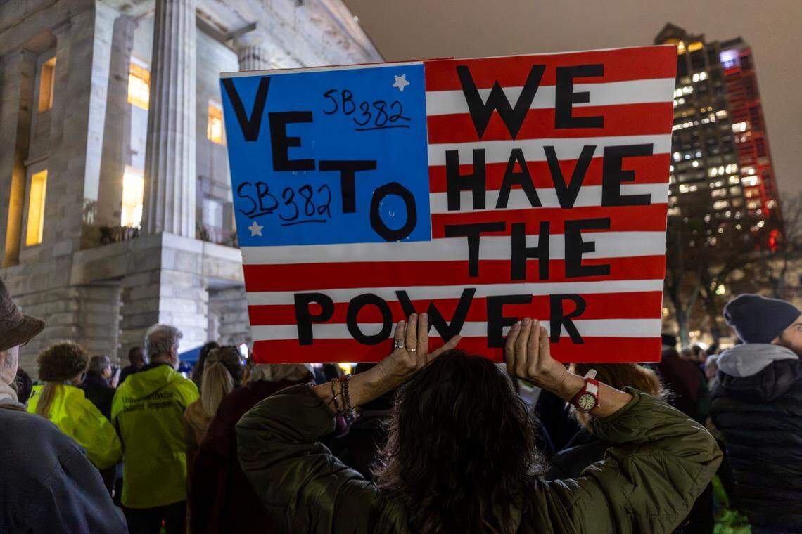 Demonstrators protest during a Moral Monday rally at the North Carolina State Capitol on Monday, Dec. 9, 2024, calling on lawmakers to uphold Gov. Roy Cooper’s veto of Senate Bill 382. Cooper vetoed the bill on Nov. 26, calling it “a sham” and criticizing its lack of hurricane relief and inclusion of various power grabs.