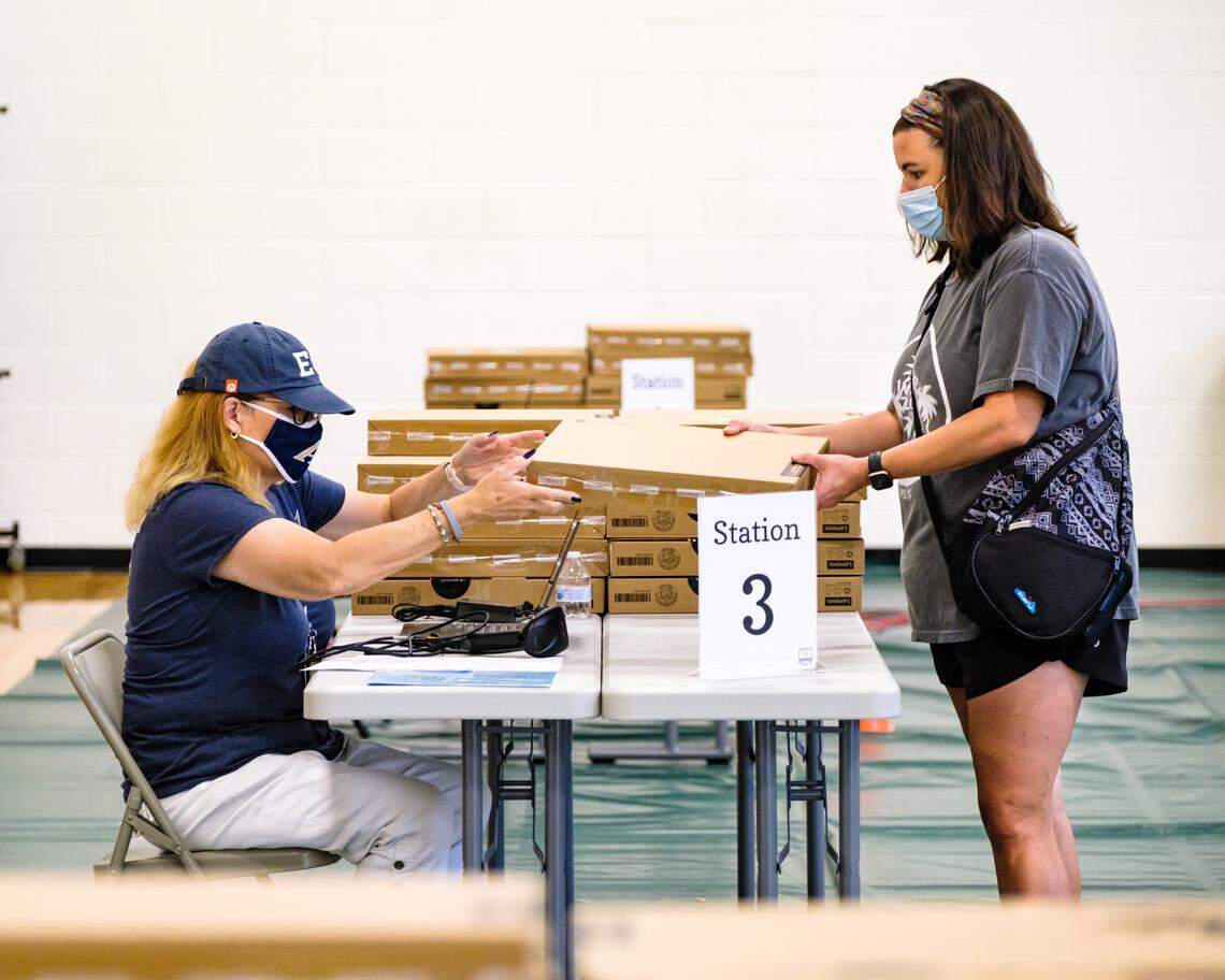Activate Good volunteers helped Wake County school system employees prepare computers and hotspots for distribution to families who need them in August. The group organizes volunteers for a variety of causes.