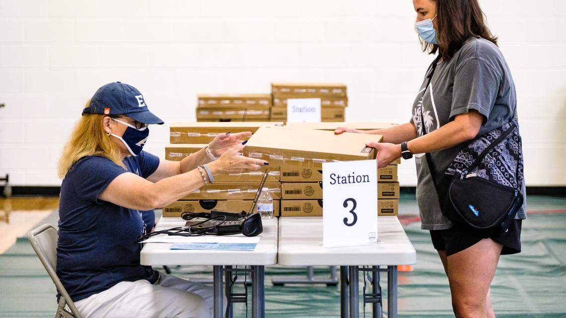 Activate Good volunteers helped Wake County school system employees prepare computers and hotspots for distribution to families who need them in August. The group organizes volunteers for a variety of causes.