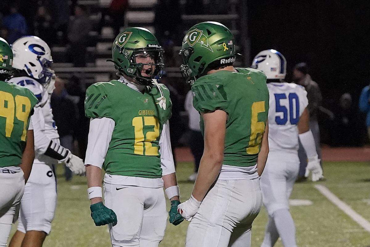 Cardinal Gibbons' Griffin Cockerham (6) and Drake Stone (12) react a play against Clayton during the first half. The Clayton Comets and the Cardinal Gibbons Crusaders met in the East Regional Final of the NCHSAA 7A Football Championship in Clayton, N.C. on December 4, 2025.