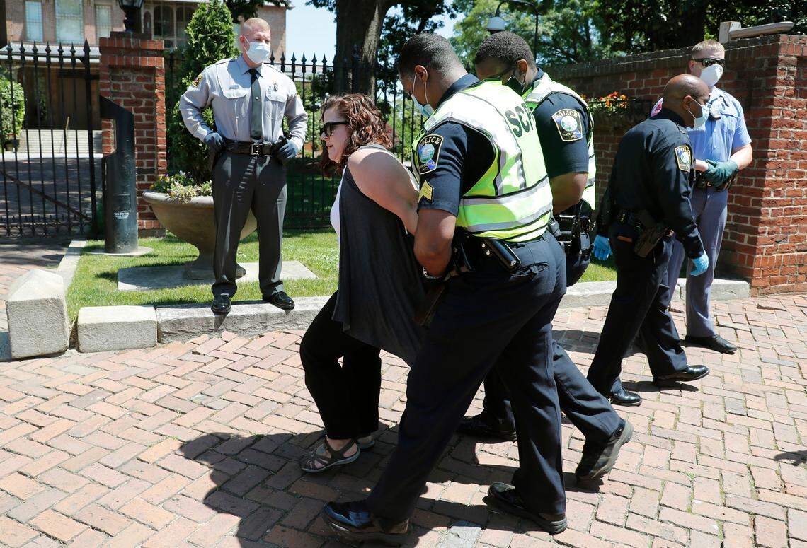 Ashley Smith, the ReOpenNC leader, is arrested outside the North Carolina Executive Mansion during the ReOpenNC protest in Raleigh, N.C., Tuesday, April 28, 2020.