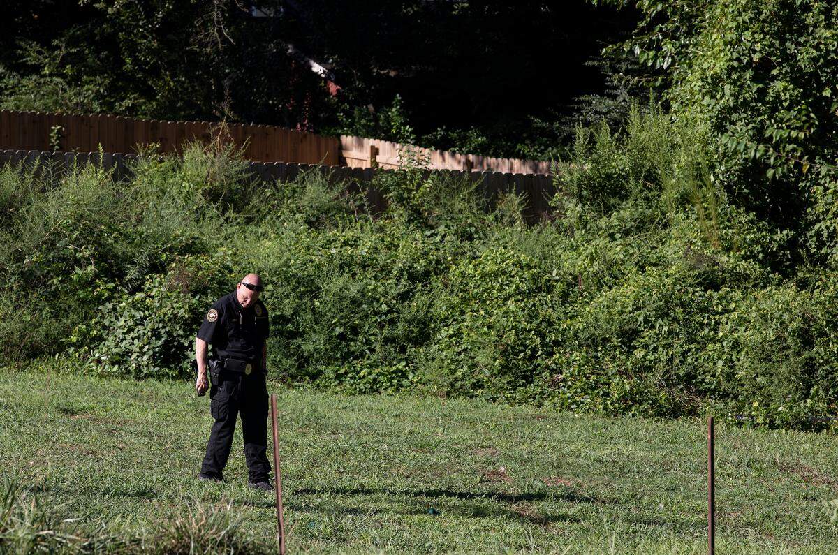 Forensic investigators work the scene near the intersection of Branch and East Streets in Raleigh, N.C. after a State Highway Patrol trooper shot and killed a 20-year-old man during an exchange of gunfire early Friday morning, Sept. 1, 2023.