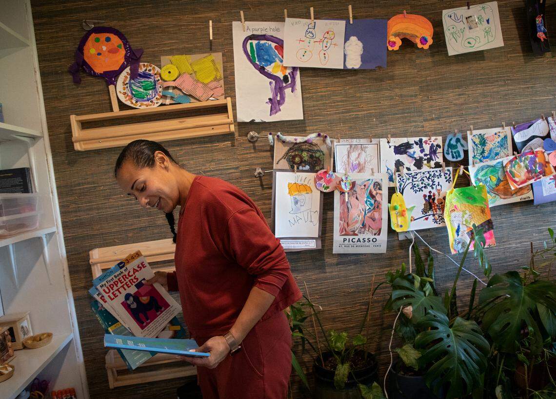 Kat Tedford, photographed at her home in Durham, N.C. on Monday, May 9, 2022, sorts through books and educational tools she acquired for her daughter’s period of remote learning during the COVID-19 pandemic. Tedford and her husband were sued by the Montessori School of Durham over lost tuition payments after they opted not to send their child to the school for the 2020-2021 school year due to the COVID-19 pandemic.