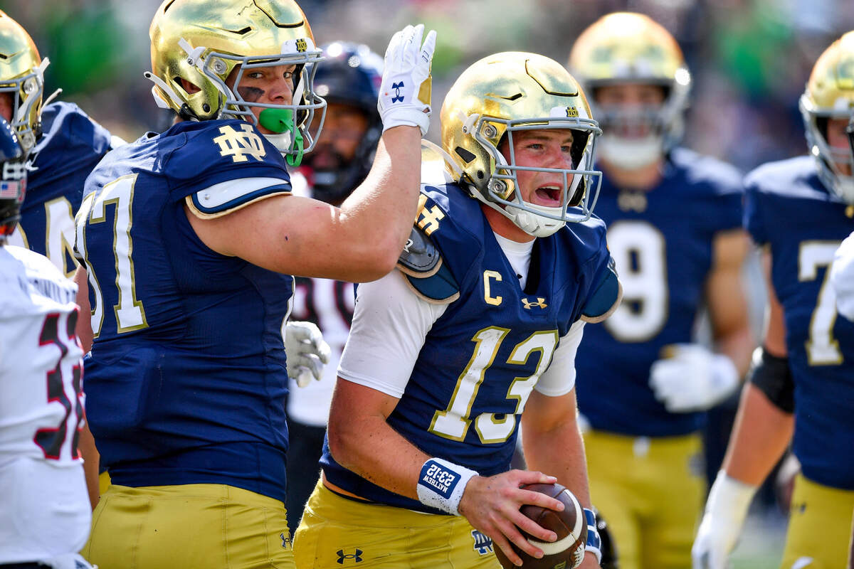 Notre Dame Fighting Irish quarterback Riley Leonard (13) celebrates after scoring a touchdown in the first quarter against the Northern Illinois Huskies at Notre Dame Stadium.