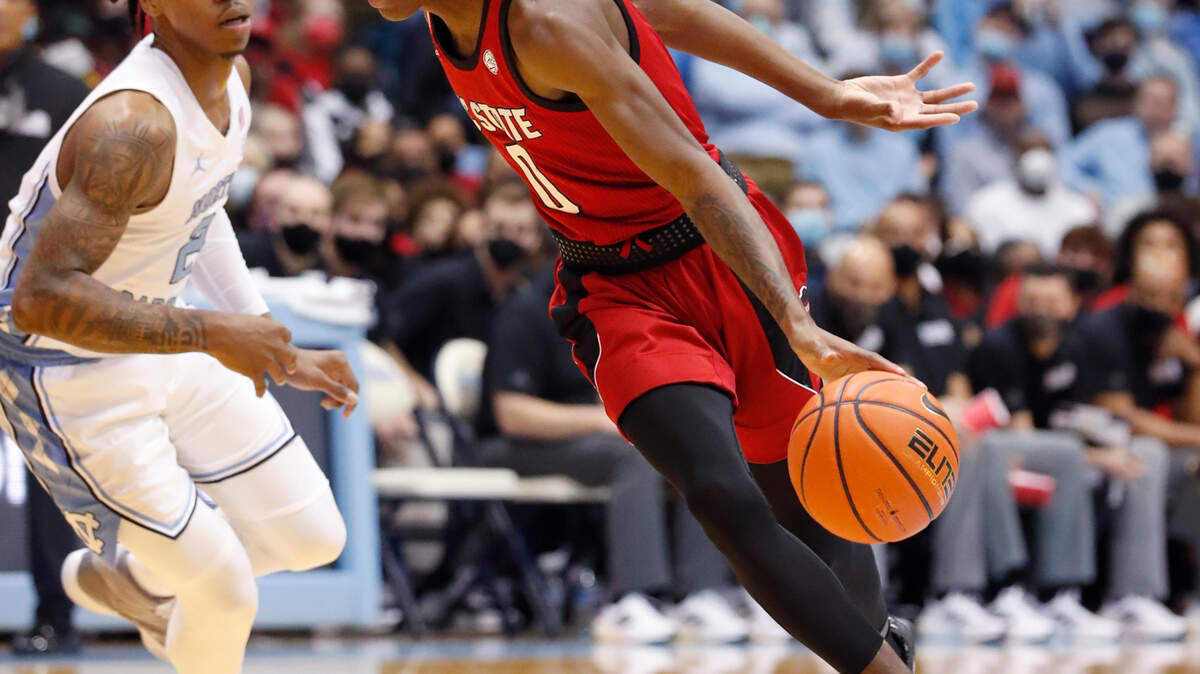 N.C. State’s Terquavion Smith (0) drives past North Carolina’s Caleb Love (2) during the first half of UNC’s game against N.C. State at the Smith Center in Chapel Hill, N.C., Saturday, Jan. 29, 2022.