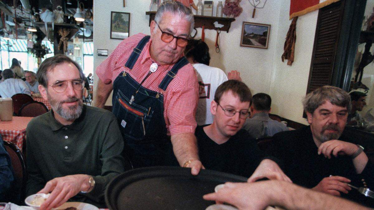 “Big Ed” Watkins makes sure everyone tries his chicken and dumplings as a group of British journalists dine at his restaurant at Raleigh’s City Market in 2000.