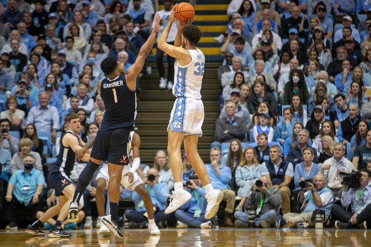 North Carolina’s Pete Nance (32) launches a three point shot over Virginia’s Jayden Gardner (1) during the first half on Saturday, February 25, 2023 at the Smith Center in Chapel Hill, N.C. Nance scored 14 points in the first half.