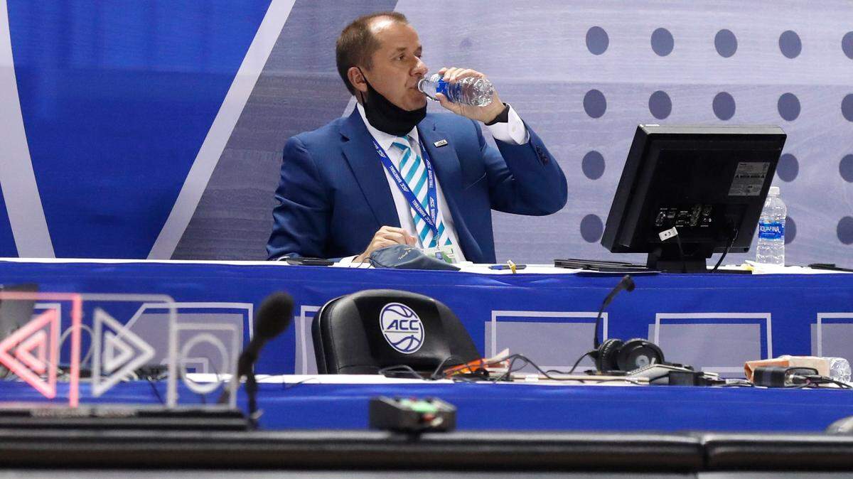 ACC Commissioner Jim Phillips takes a drink during a break in Duke’s 70-56 victory over Louisville in the second round of the ACC Men’s Basketball Tournament in Greensboro, N.C., Wednesday, March 10, 2021.
