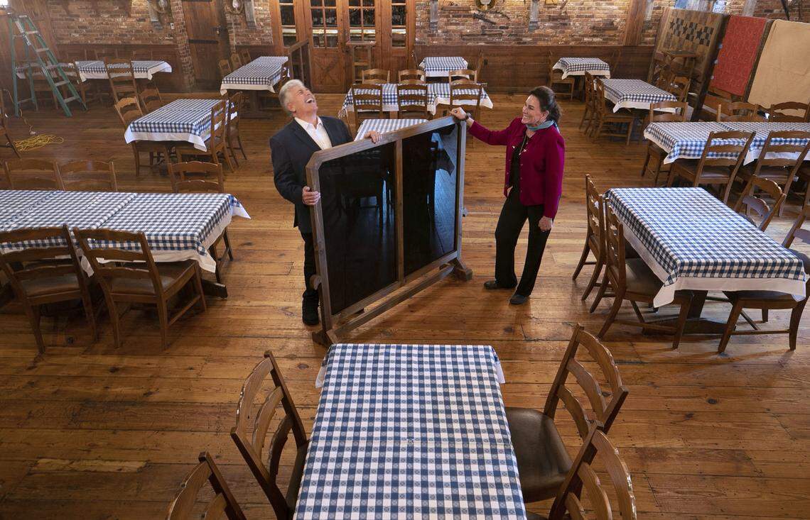 Van Eure and Steve Thanhauser, owners of the Angus Barn, set up one of their dining rooms in anticipation of re-opening in Phase Two of Gov. Roy Cooper’s plan to lift coronavirus restrictions on Tuesday, May 19, 2020 in Raleigh, N.C.. The Angus Barn has reduced their seating by half, and have installed moveable partitions to help separate dining tables and make customers feel comfortable dining inside again.
