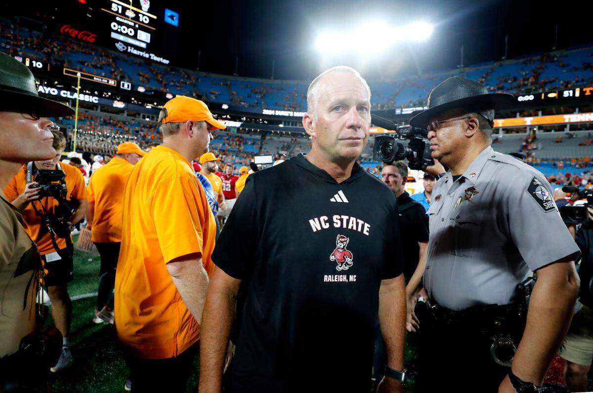 N.C. State head coach Dave Doeren walks away after congratulating Tennessee head coach Josh Heupel after Tennessee’s 51-10 victory over N.C. State in the Duke’s Mayo Classic at Bank of America Stadium in Charlotte, N.C., Saturday, Sept. 7, 2024.