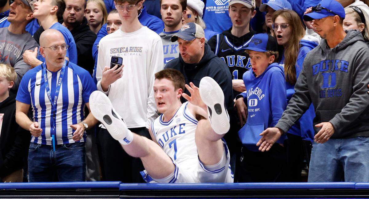 Duke’s Kon Knueppel (7) falls into the stands after chasing after a loose ball during the first half of Duke’s game against Seattle at Cameron Indoor Stadium in Durham, N.C., Friday, Nov. 29, 2024.