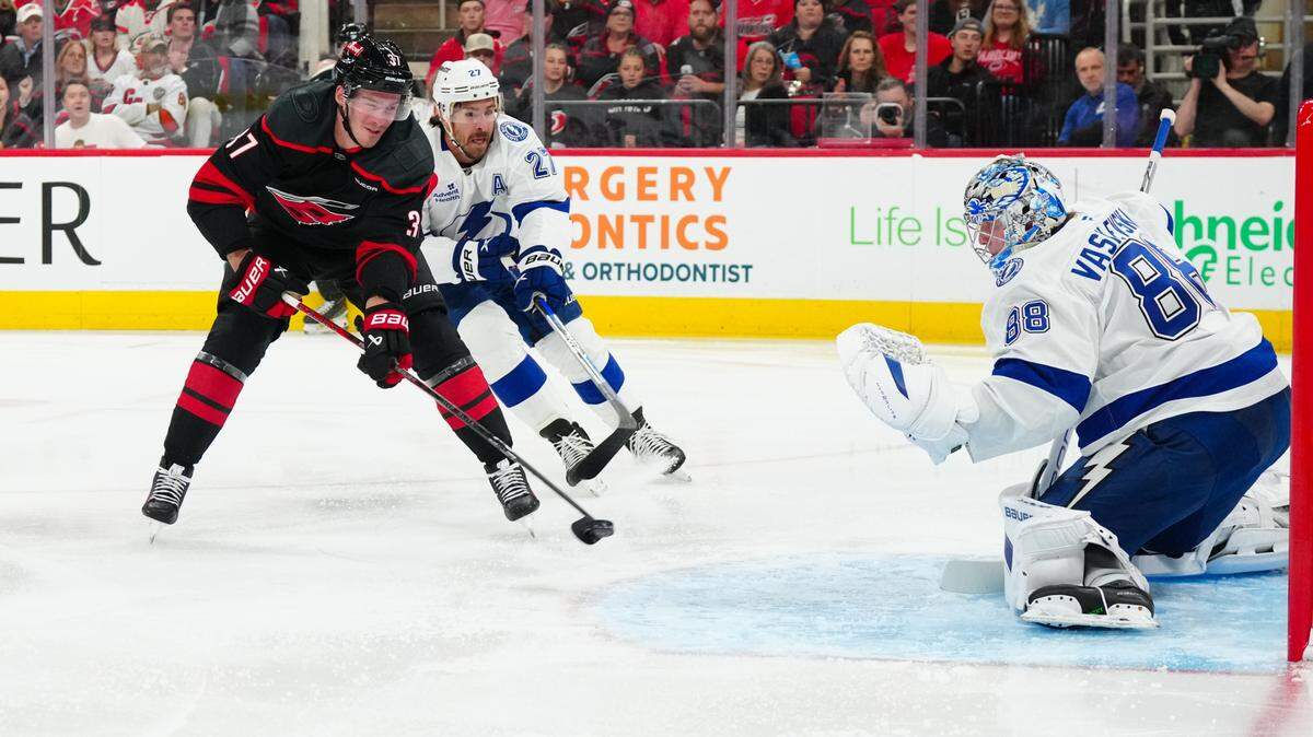 Carolina Hurricanes right wing Andrei Svechnikov (37) has a scoring attempt against Tampa Bay Lightning goaltender Andrei Vasilevskiy (88) and defenseman Ryan McDonagh (27) during the first period at Lenovo Center.