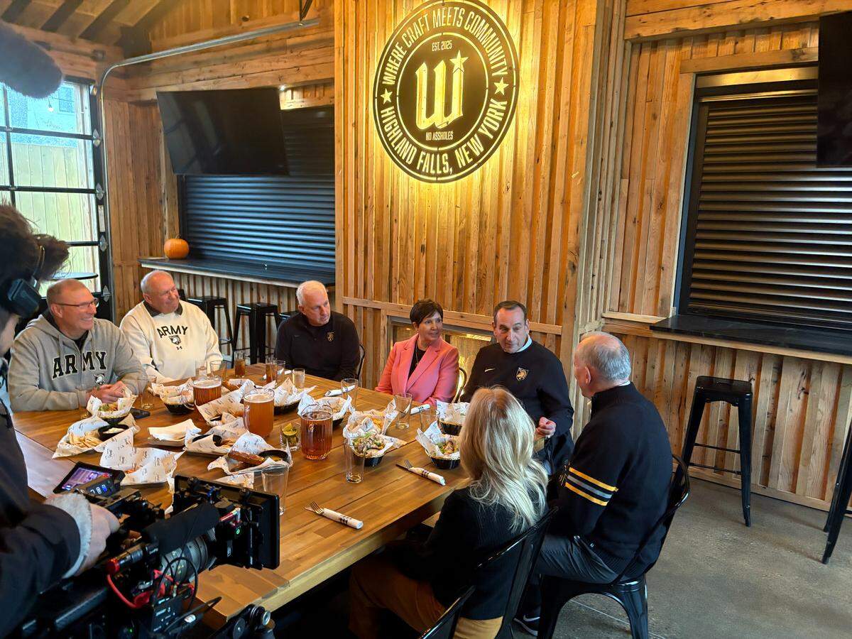 Mike Krzyzewski, second from right, and his wife Mickie join a group of his former Army players for lunch on Veterans Day, hours before Army honored the former Duke and Army coach for his accomplishments ahead of a game between his two former schools.