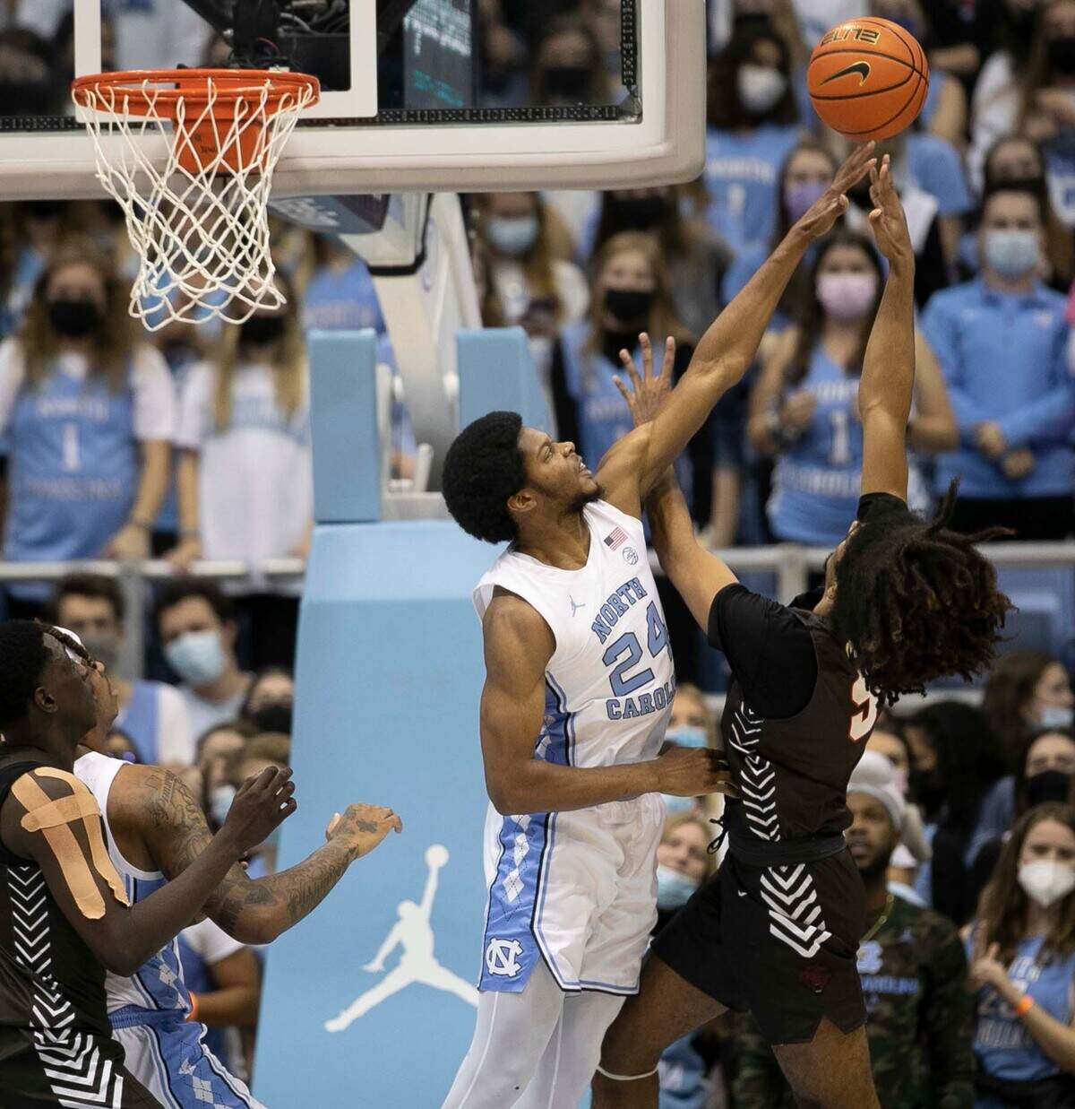 North Carolina’s Kerwin Walton (24) defends Brown’s Noah Meren (5) during the first half on Friday, November 12, 2021 at the Smith Center in Chapel Hill, N.C.