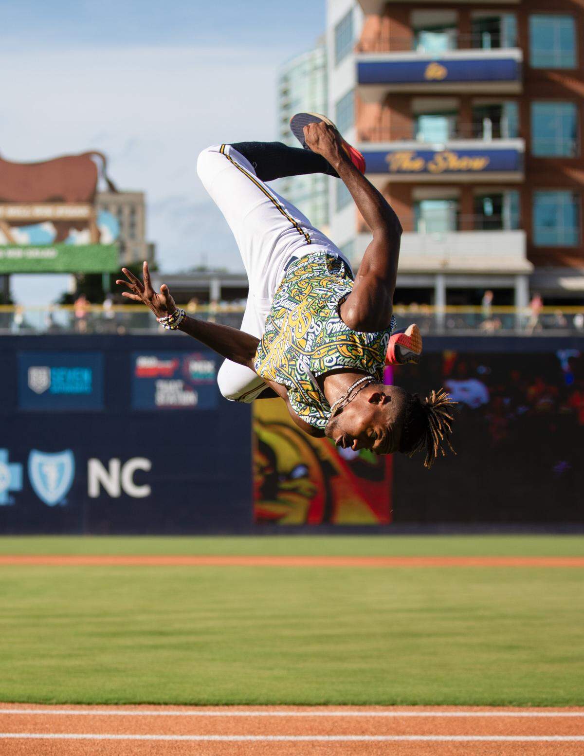 First base coach Maceo Harrison does a flip ahead of the Savannah Bananas game against the Party Animals at Durham Bulls Athletic Park in Durham, N.C. on Friday, July 14, 2023.
