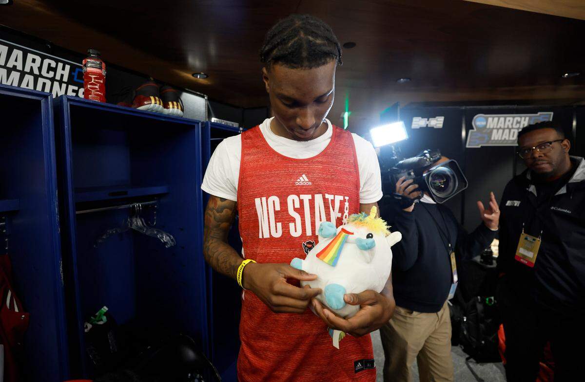 N.C. State’s Ernest Ross holds onto Tommy in the locker room before the Wolfpack’s practice at Ball Arena in Denver, Colo. Thursday, March 16, 2023. The Wolfpack will face Creighton in the first round of the NCAA Tournament Friday.