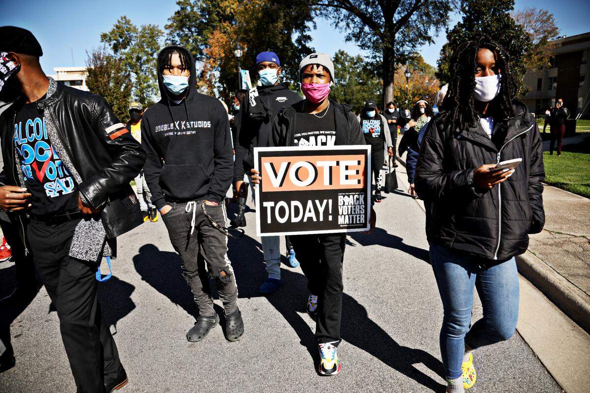 Saint Augustine’s University students gather on campus Tuesday, Nov. 3, 2020, to march to the polls at Tarboro Road Community Center in Raleigh.