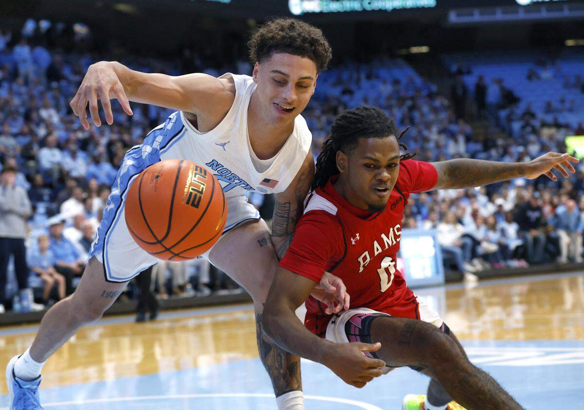 North Carolina’s Kyan Evans and Winston-Salem State’s Jaiden Thompson scramble for a loose ball during the first half of the Tar Heels’ exhibition game on Wednesday, Oct. 29, 2025, at the Smith Center in Chapel Hill, N.C.