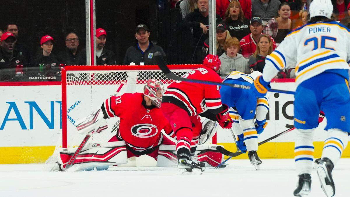 Nov 7, 2023; Raleigh, North Carolina, USA; Carolina Hurricanes goaltender Antti Raanta (32) stops the scoring attempt by Buffalo Sabres center Peyton Krebs (19) during the first period at PNC Arena. Mandatory Credit: James Guillory-USA TODAY Sports