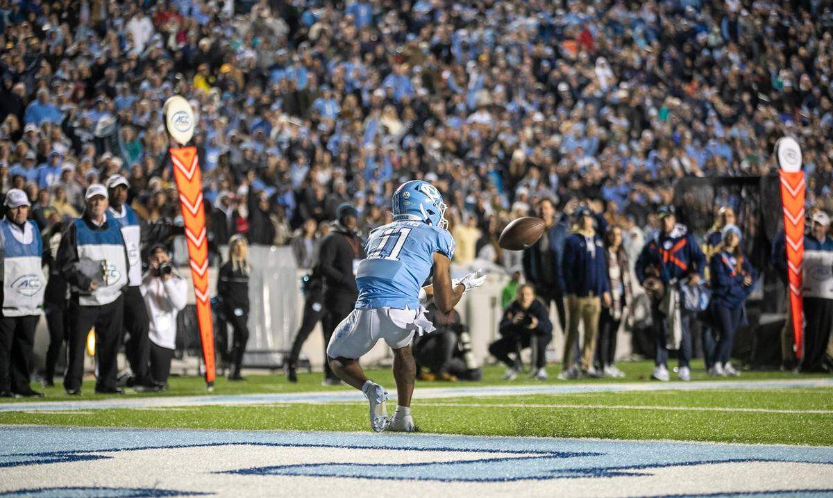 North Carolina’s Josh Downs (11) works to pull in a 19-yard pass from quarterback Drake Maye on fourth down with 4:10 to play in the fourth quarter on Saturday, November 19, 2022 at Kenan Stadium in Chapel Hill, N.C. Downs dropped the ball and the Tar Heels fell to the Yellowjackets 21-17.