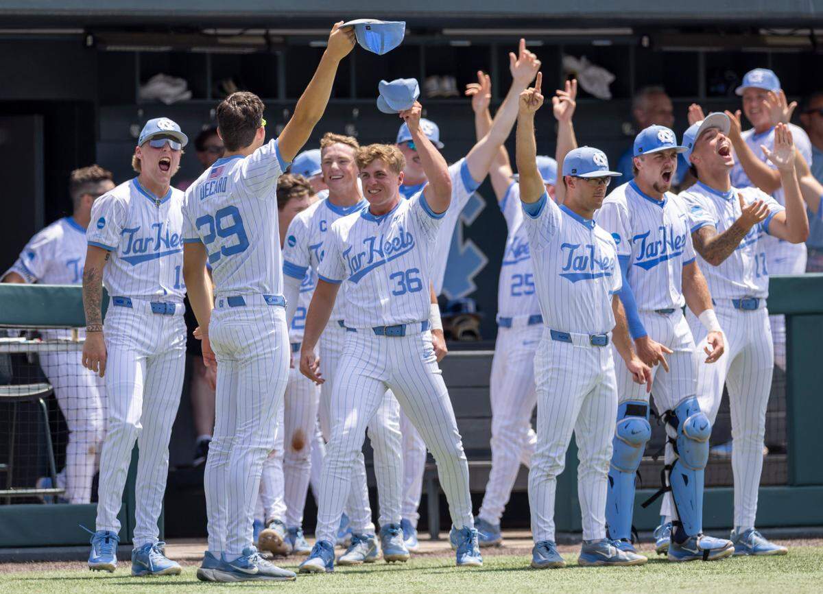 North Carolina pitcher Jason DeCaro (29) leads the celebration in the Tar Heels dugout after first baseman Hunter Stokley (45) connected for a 3 RBI home run in the first inning to take a 5-1 lead over Arizona during the NCAA Super Regional on Friday, June 6, 2025 at Boshamer Stadium in Chapel Hill, N.C.