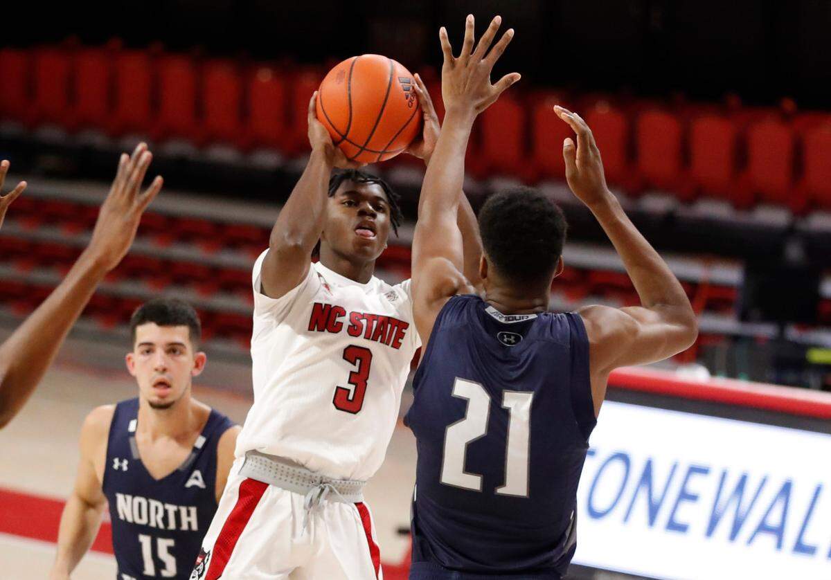 N.C. State’s Cam Hayes (3) shoots as North Florida’s Jonathan Aybar (21) defends during the second half of N.C. State’s 86-51 victory over North Florida in the Mako Medical Wolfpack Invitational at Reynolds Coliseum in Raleigh, N.C., Friday, Nov. 27, 2020.