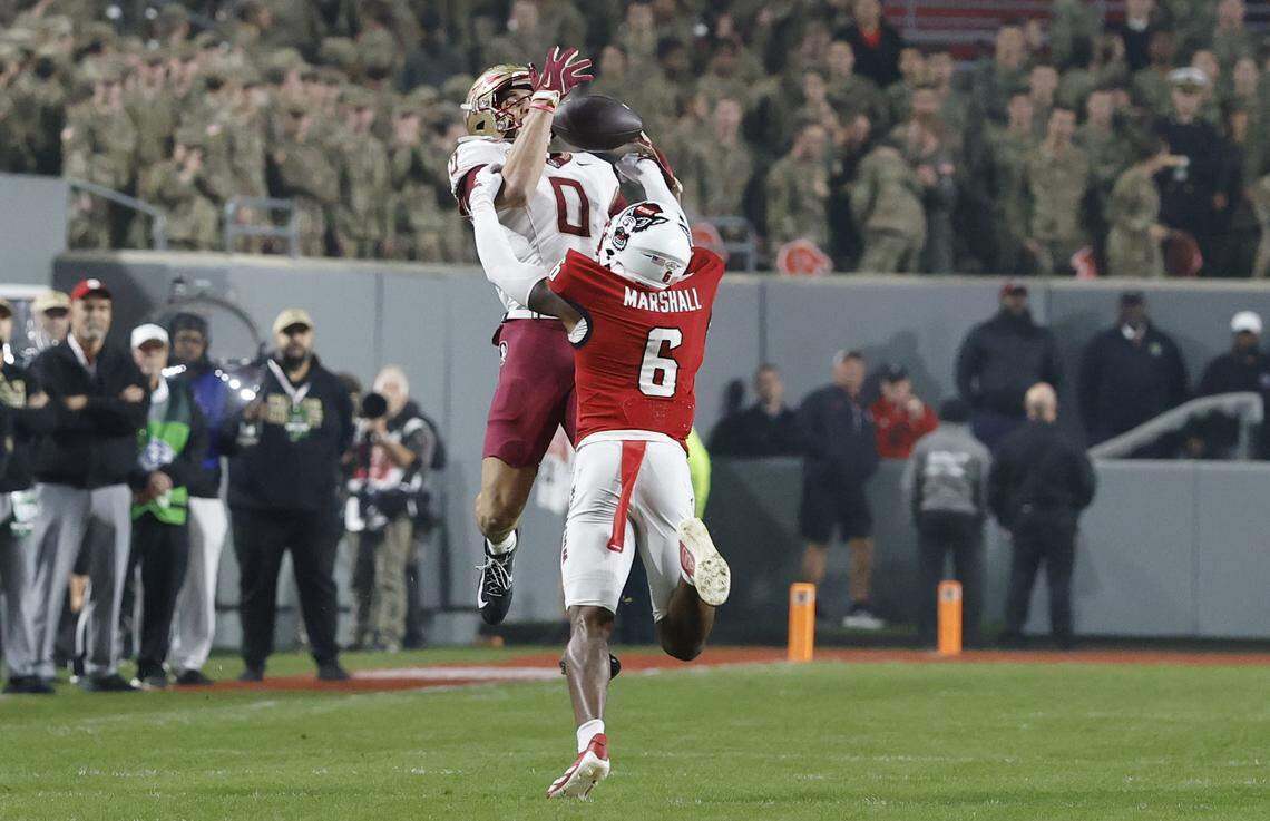 N.C. State defensive back Devon Marshall (6) breaks up the pass intended for Florida State wide receiver Duce Robinson (0) during the first half of N.C. State’s game against Florida State at Carter-Finley Stadium in Raleigh, N.C., Friday, Nov. 21, 2025.