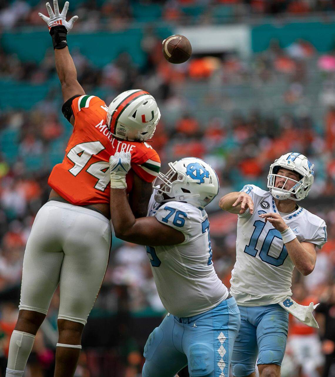 Miami defensive lineman Antonio Moultrie (44) pressure North Carolina quarterback Drake Maye (10) in the second quarter on Saturday, October 8, 2022 at Hard Rock Stadium in Miami Gardens, Florida.