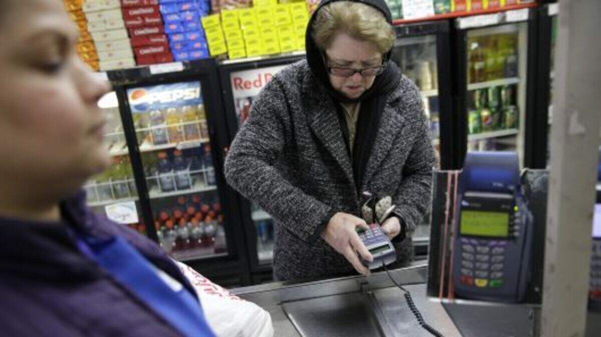 A woman pays for her groceries using a food stamp program at a supermarket in West New York, N.J., Monday, Jan. 12, 2015.