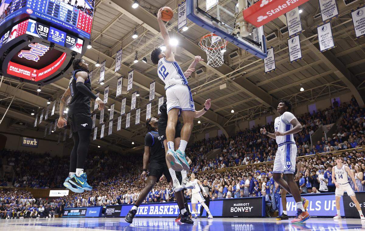 Duke’s Cameron Boozer (12) slams in two over SMU’s Samet Yigitoglu (24) during Duke’s 82-75 victory over SMU at Cameron Indoor Stadium in Durham, N.C., Saturday, Jan. 10, 2026.