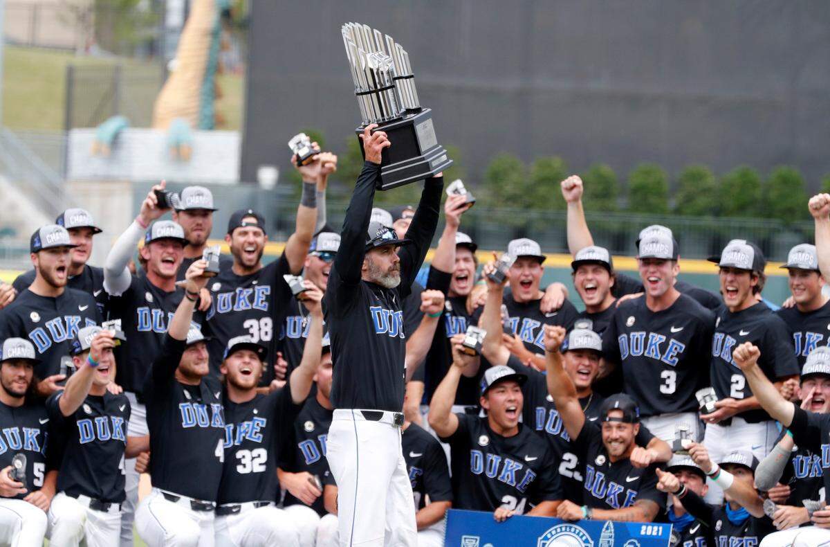 Duke head coach Chris Pollard holds up the trophy after Duke’s 1-0 victory over N.C. State to win the ACC Baseball Championship game at Truist Field in Charlotte, N.C., Sunday, May 30, 2021.