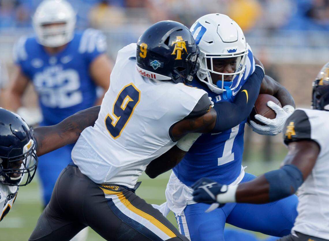 Duke Blue Devils running back Jordan Waters runs the ball under pressure from North Carolina A&T Aggies defensive back Janaz Sumpter during the first half of Dukes game against North Carolina A&T at Wallace Wade Stadium in Durham, N.C. on Saturday, Sept. 17, 2022.