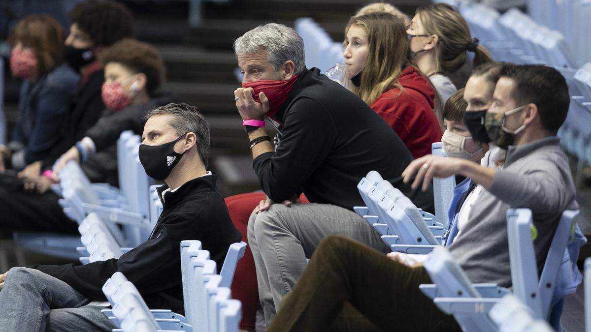 N.C. State athletic director Boo Corrigan, center, watches the second half of the Wolfpack’s game against North Carolina on Saturday, January 23, 2021 at the Smith Center in Chapel Hill, NC.