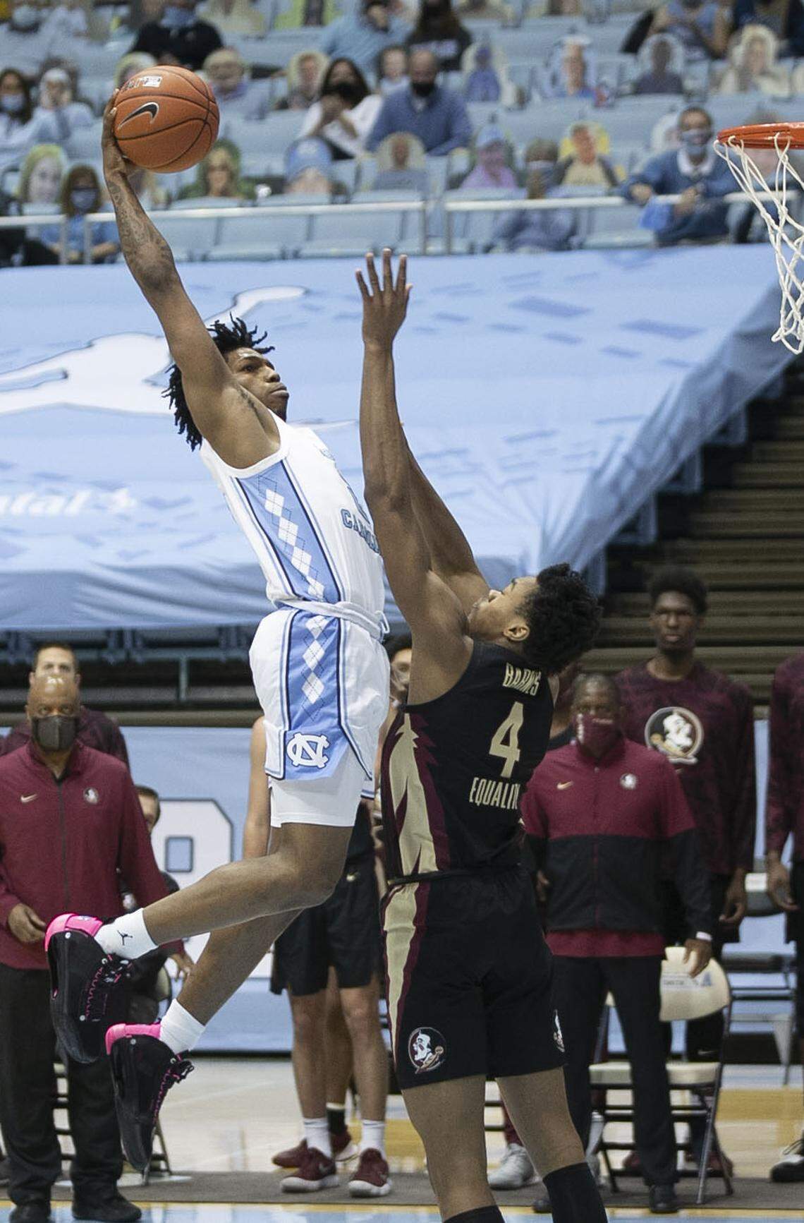 North Carolina’s Caleb Love (2) drives to the basket against Florida State’s Scottie Barnes (4) during the first half on Saturday, February 27, 2021 in Chapel Hill, N.C.