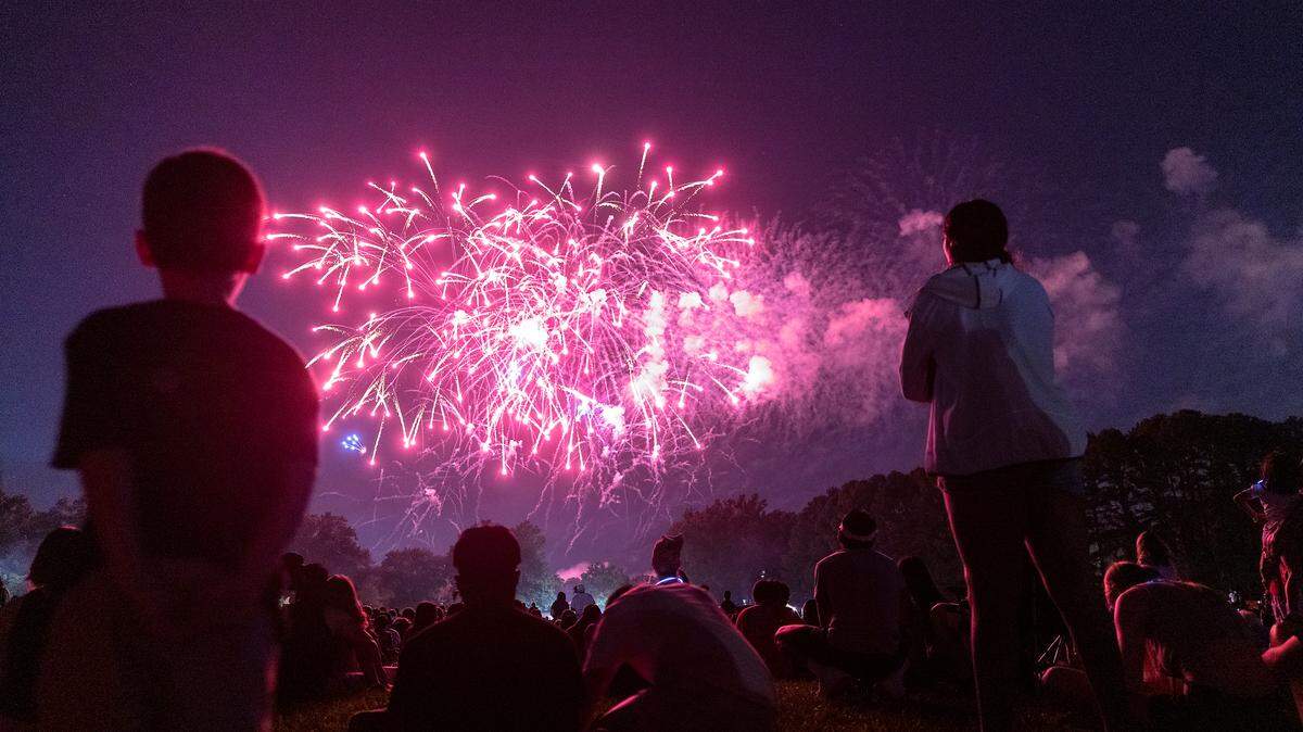 Crowds watch a fireworks display during an Independence Day celebration at Dorothea Dix Park on Tuesday, July 4, 2023, in Raleigh, N.C.
