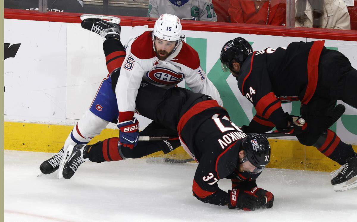 Montréal's Alex Newhook (15) tangles with Carolina's Andrei Svechnikov (37) during the first period of the Hurricanes’ game against the Canadiens in game five of the Eastern Conference Finals at the Lenovo Center Friday, May 29, 2026.